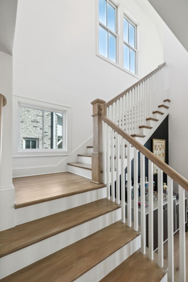 staircase with a towering ceiling