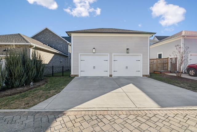 exterior space featuring a garage and an outbuilding