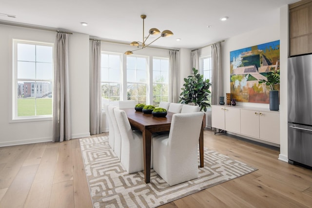 dining area featuring a chandelier and light wood-type flooring