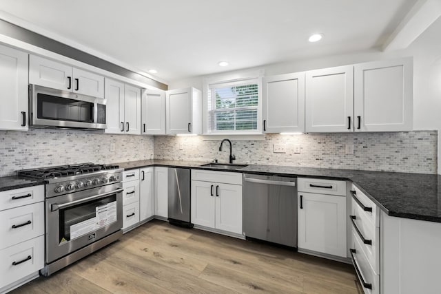 kitchen featuring sink, white cabinets, and appliances with stainless steel finishes