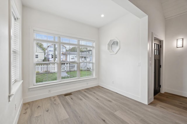 empty room with light hardwood / wood-style flooring