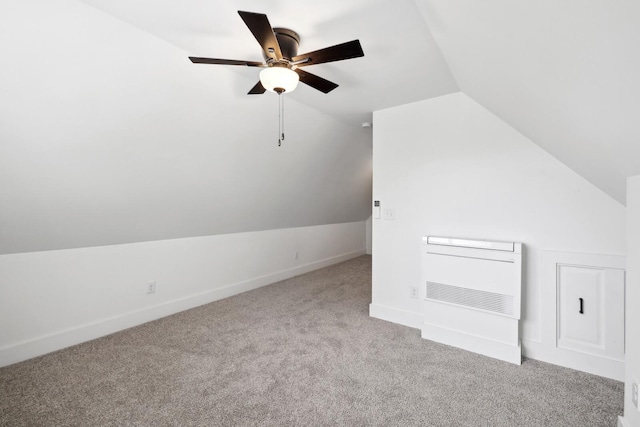 additional living space with heating unit, ceiling fan, lofted ceiling, and light carpet