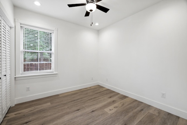 spare room with hardwood / wood-style floors and ceiling fan