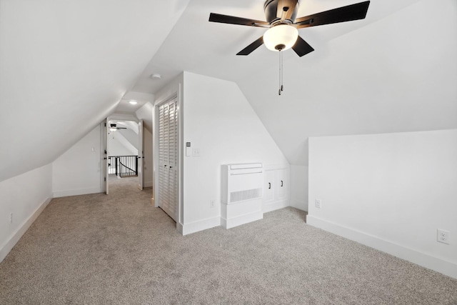 additional living space with ceiling fan, lofted ceiling, and light carpet