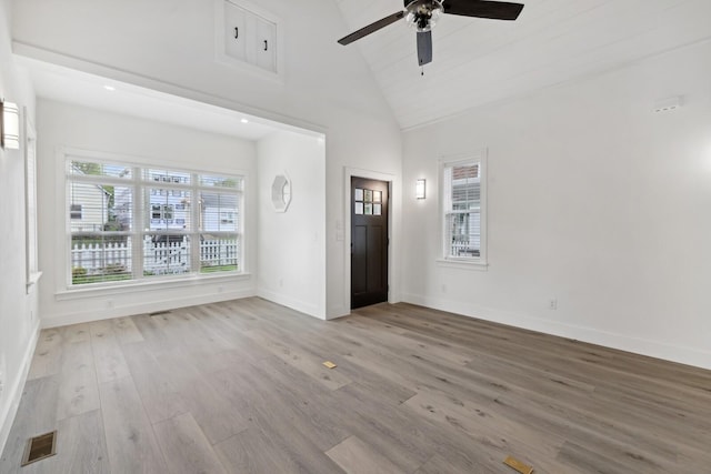 unfurnished living room featuring ceiling fan, high vaulted ceiling, and light hardwood / wood-style flooring