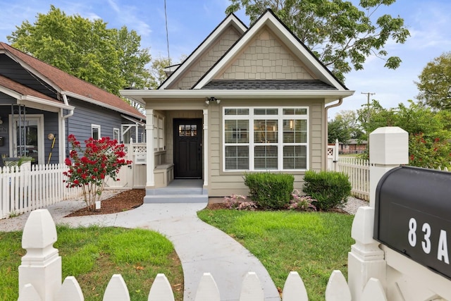 bungalow-style home featuring a front lawn