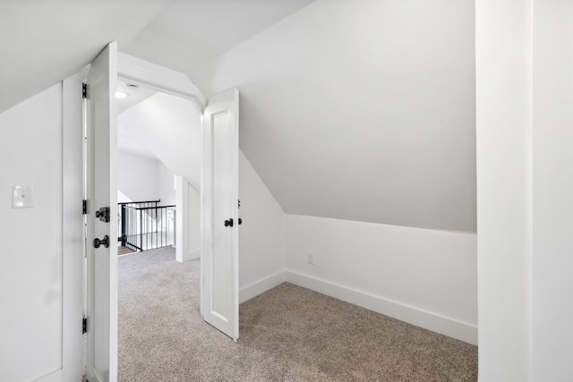 bonus room featuring lofted ceiling and light colored carpet