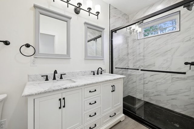 bathroom with a shower with door, vanity, wood-type flooring, and toilet