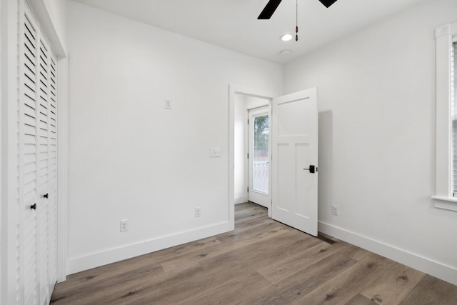 unfurnished bedroom featuring ceiling fan and light wood-type flooring