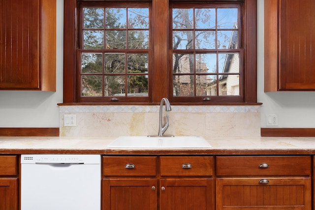 kitchen with dishwasher, sink, and backsplash