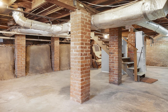 basement featuring brick wall