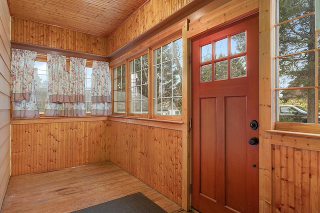 unfurnished sunroom with wooden ceiling