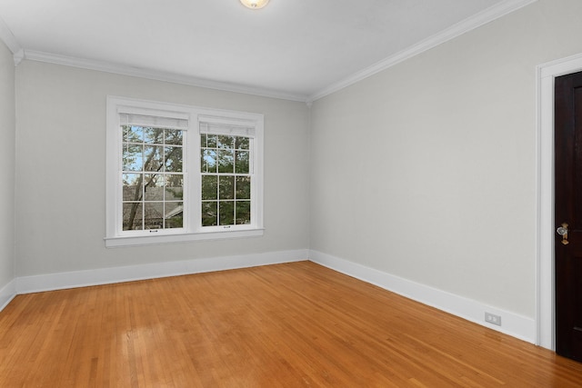 spare room featuring hardwood / wood-style flooring and crown molding