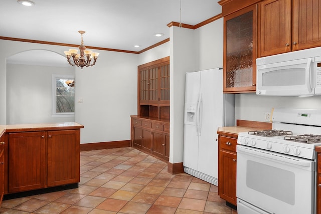 kitchen with hanging light fixtures, crown molding, light tile patterned flooring, and white appliances