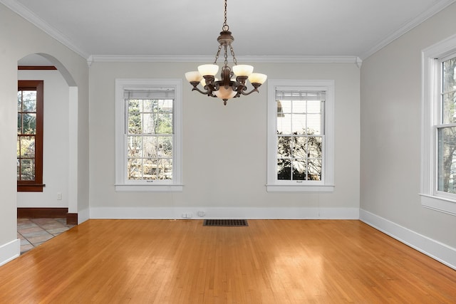 unfurnished dining area featuring a healthy amount of sunlight and hardwood / wood-style floors