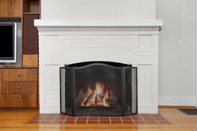 interior details with hardwood / wood-style flooring and a fireplace