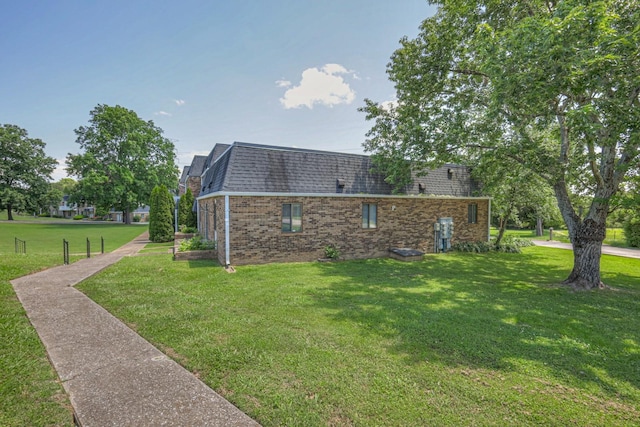 view of side of property with a yard