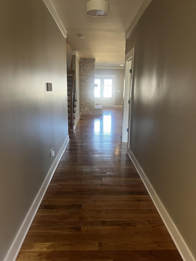 corridor with dark hardwood / wood-style flooring