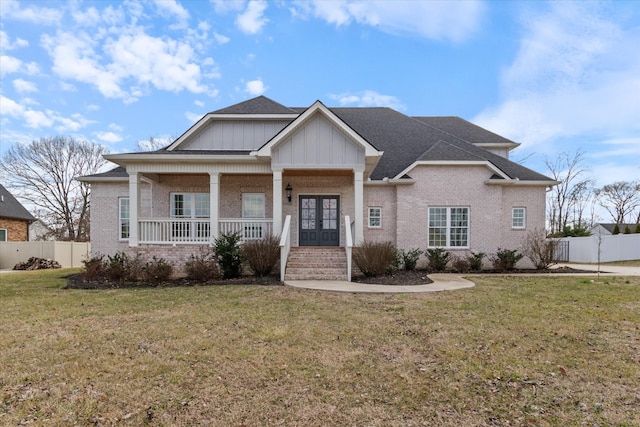 view of front of property featuring a front lawn and covered porch