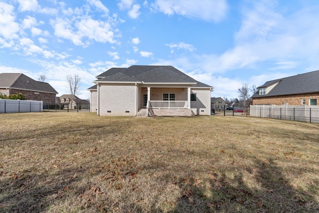 rear view of property with a lawn