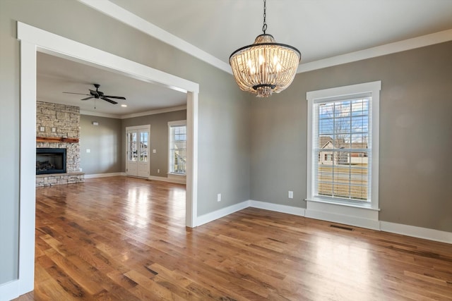 interior space featuring wood-type flooring, plenty of natural light, and crown molding