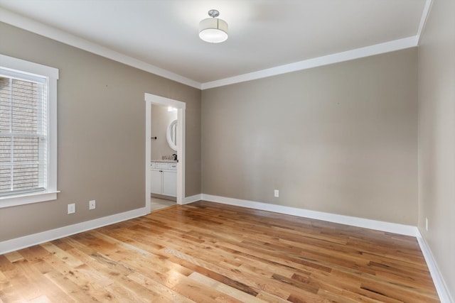 spare room with crown molding and wood-type flooring