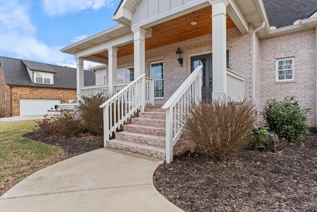 entrance to property with a garage and a porch