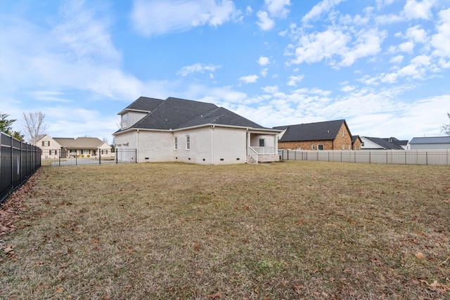 back of property featuring a lawn