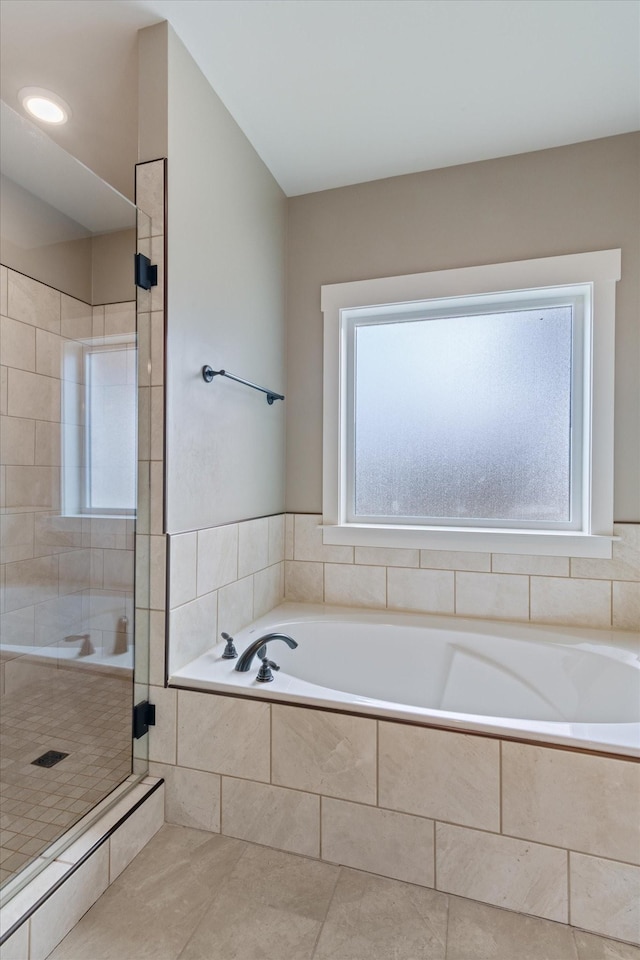 bathroom with tile patterned floors and shower with separate bathtub