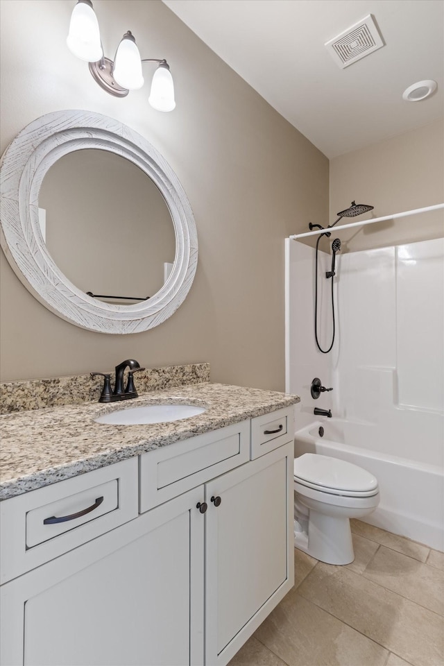 full bathroom with tile patterned floors, vanity, toilet, and  shower combination