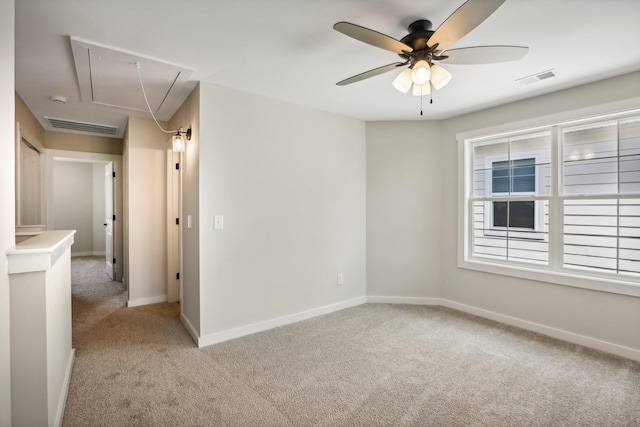 unfurnished room with light colored carpet and ceiling fan