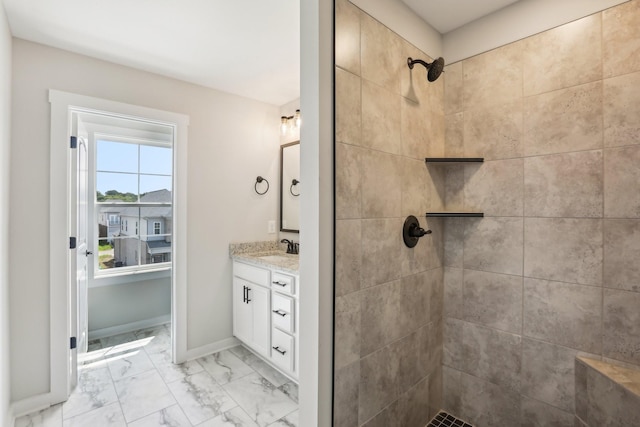 bathroom with vanity and a tile shower