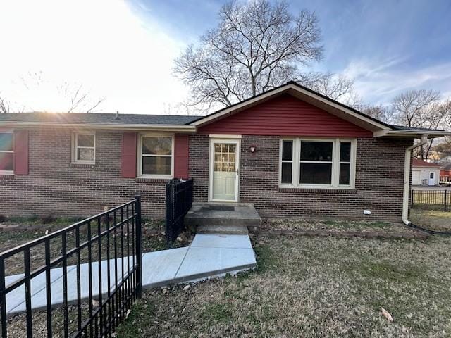 ranch-style home with a front lawn