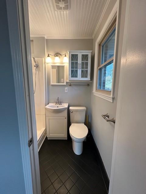 bathroom with toilet, a shower, crown molding, vanity, and tile patterned flooring