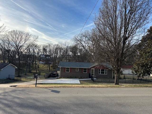 ranch-style home with fence