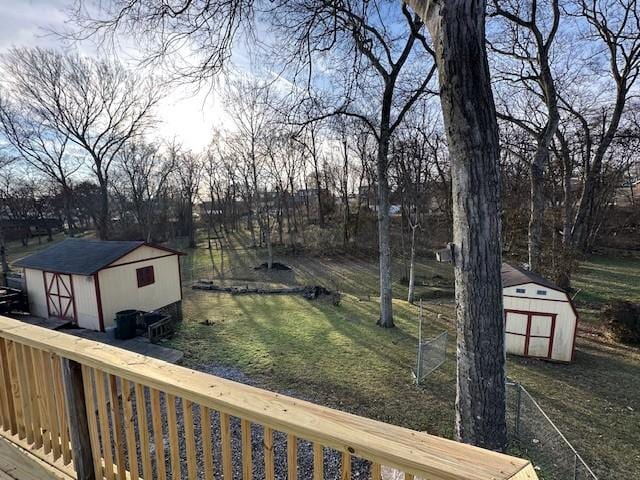 view of yard with a deck and a storage unit