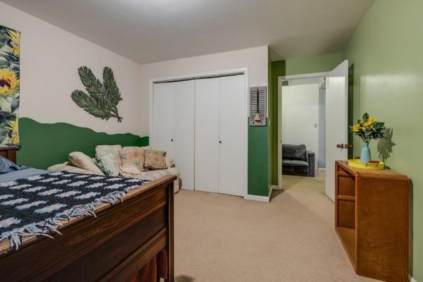 carpeted bedroom featuring a closet