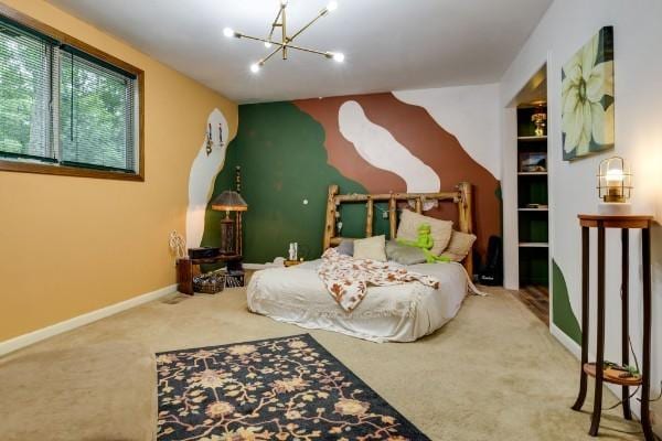 bedroom featuring an inviting chandelier and carpet flooring