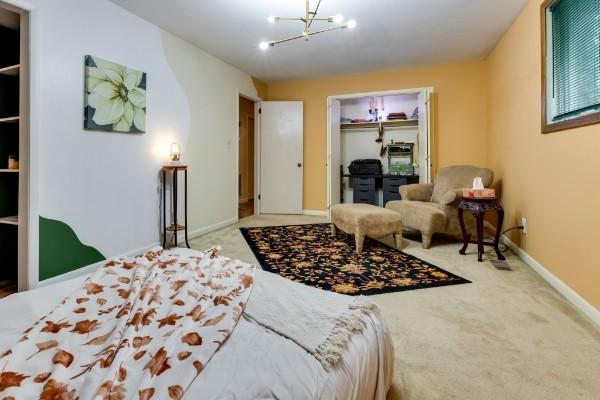 bedroom featuring a notable chandelier, a closet, and carpet flooring