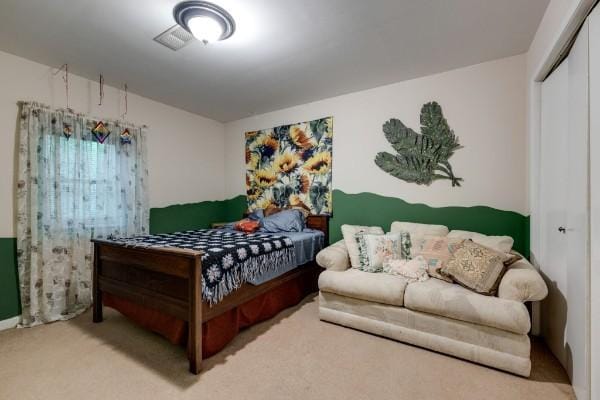 bedroom with carpet and a closet