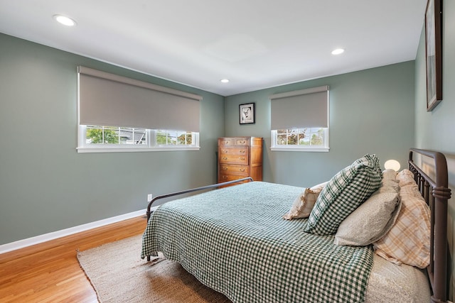 bedroom featuring multiple windows and hardwood / wood-style flooring