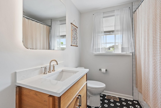 bathroom with vanity, walk in shower, and toilet