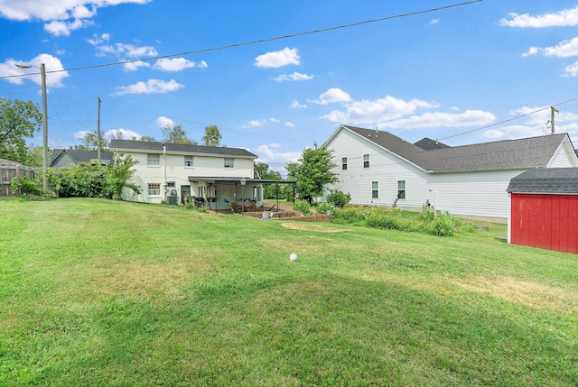 view of yard featuring a shed and a patio area