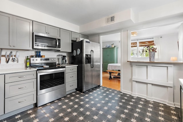 kitchen featuring stainless steel appliances and gray cabinetry