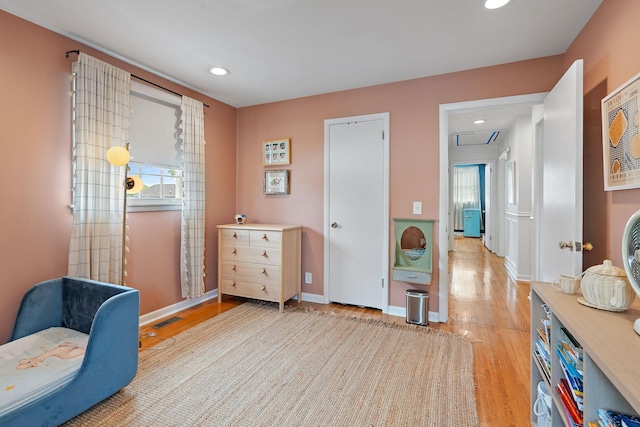 living area featuring a wealth of natural light and light hardwood / wood-style floors