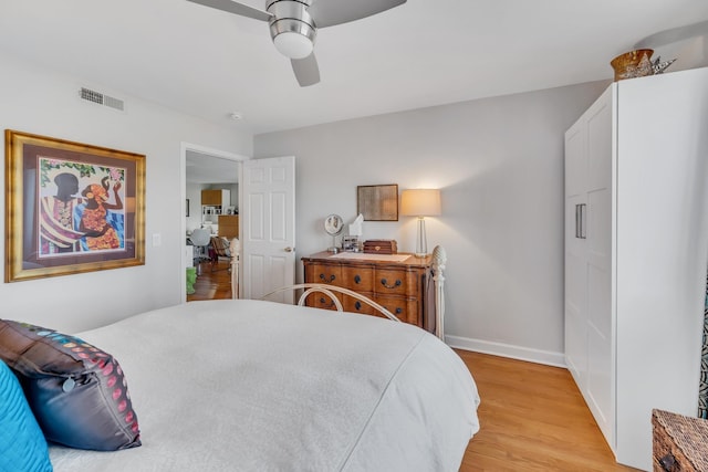 bedroom with ceiling fan and light hardwood / wood-style floors