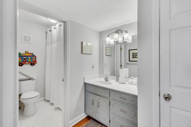 bathroom featuring tile patterned flooring, vanity, curtained shower, and toilet