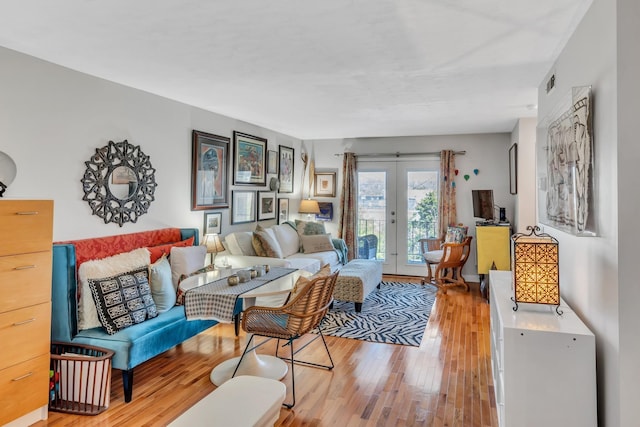 living room with light wood-type flooring and french doors