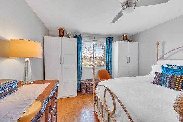 bedroom with light hardwood / wood-style flooring and ceiling fan