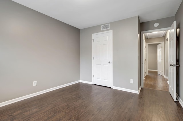 unfurnished bedroom featuring dark hardwood / wood-style flooring